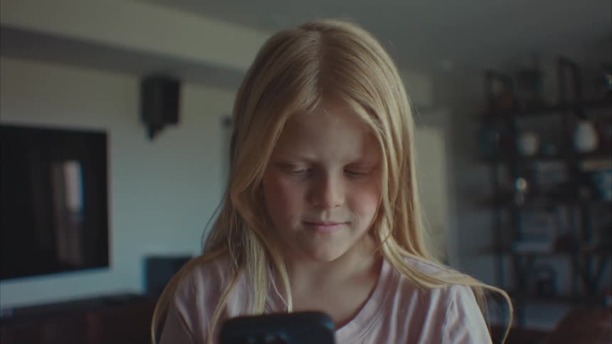 A girl using a smartphone at home