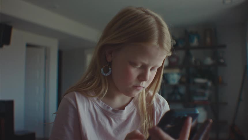 Portrait of a concentrated girl while using her cell phone