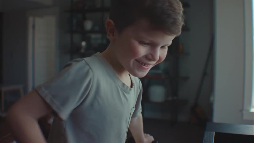 Portrait of a little boy in an indoor room having fun while playing at a games table