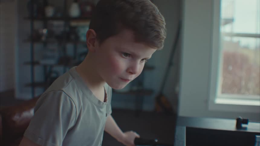 Portrait of a little boy playing foosball and having fun