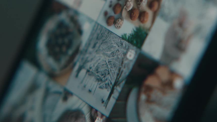 Extreme closeup on a cell phone screen with photos scrolling on instagram