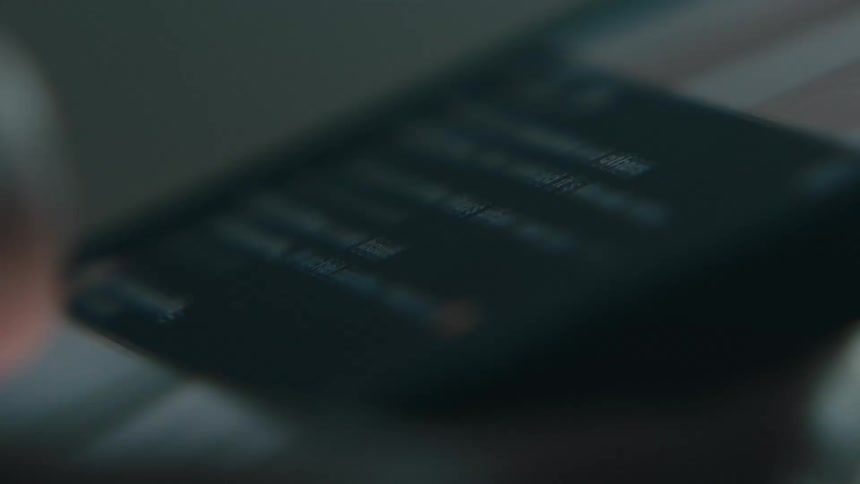 Extreme closeup of a persons finger scrolling through images on their cell phone