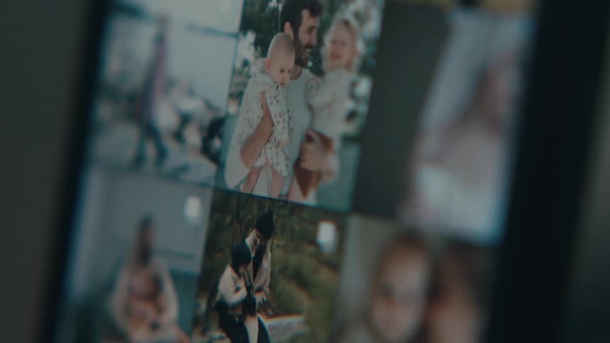 Extreme closeup on a cell phone screen with photos scrolling