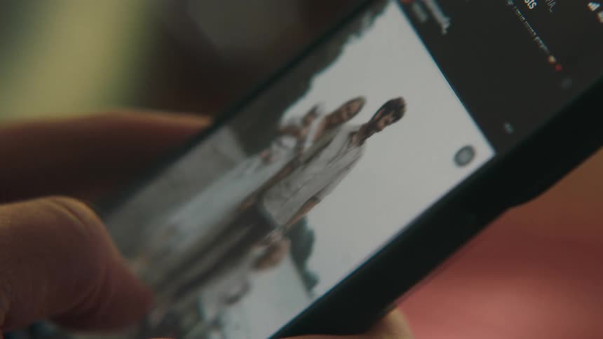 A person scrolls through pictures on a smartphone