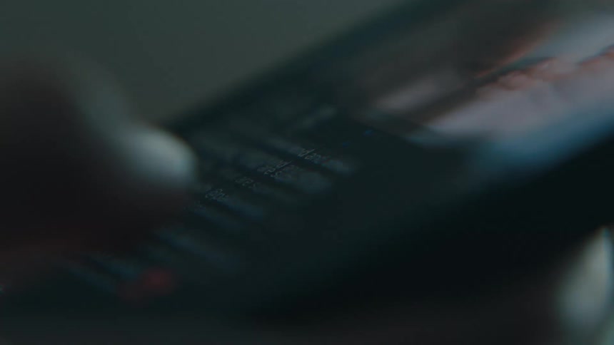 A person scrolls through photos on a phone