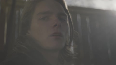 A man is standing outside looking ahead
