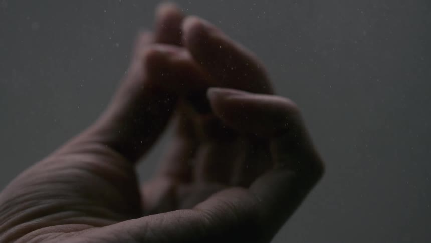 The fingers on a hand are unfurling