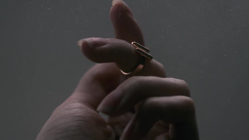 Dust falls around a woman's hand
