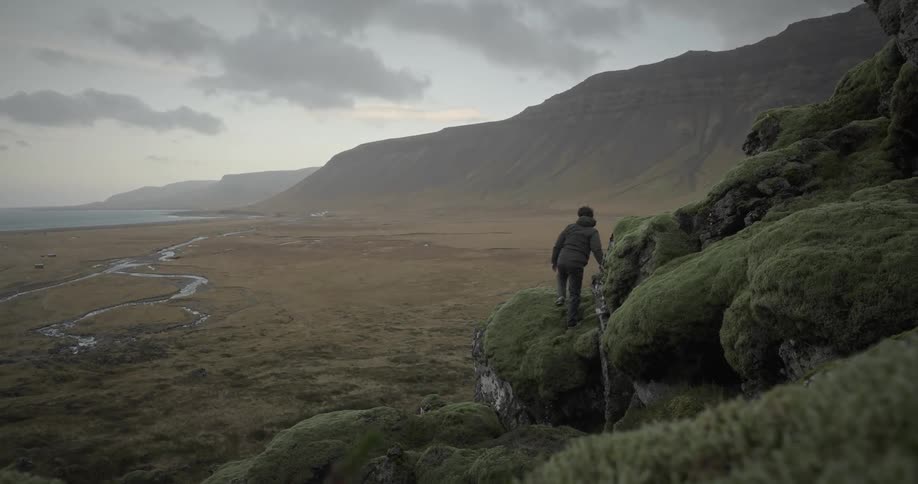 Man climbing a rock on a mountain cliff