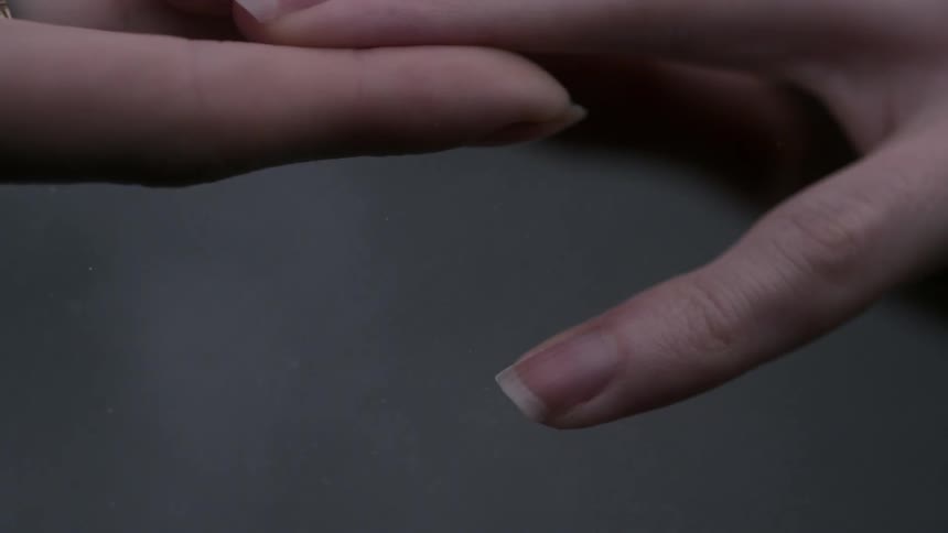 A male and female hand are parting