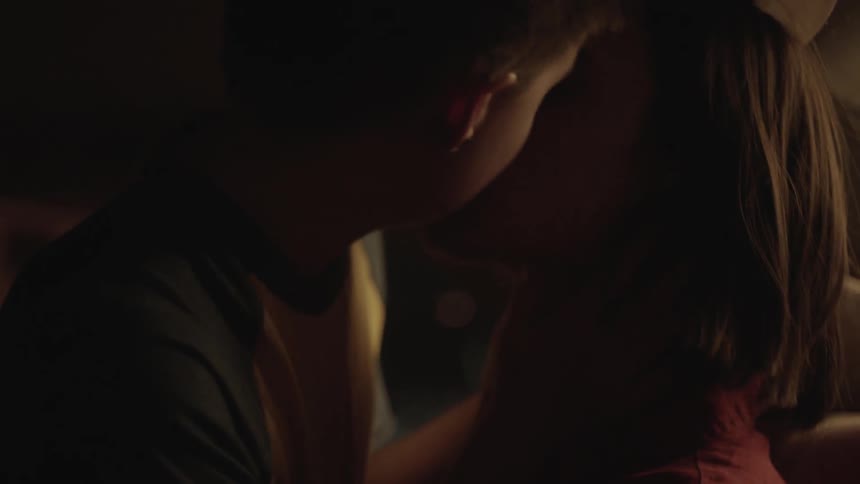 A man and woman are kissing
