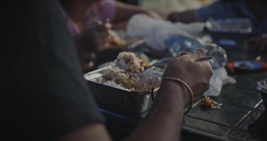 People eating packed meals