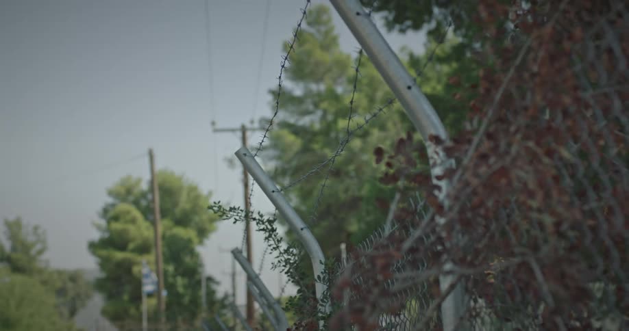 An outdoor barbed wire fence