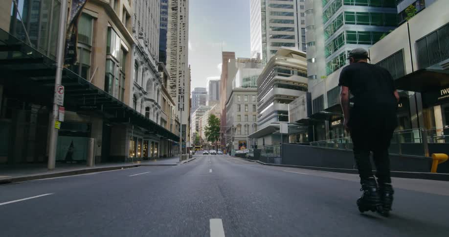 A man is rollerblading in the city