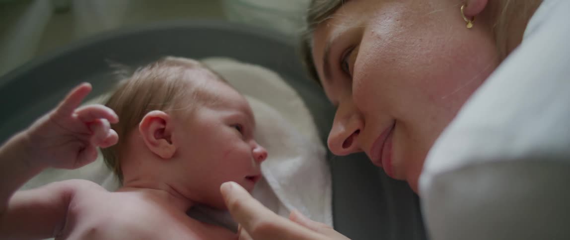 A mother kisses her baby