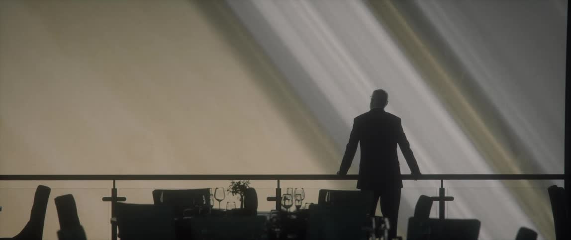 A man in a restaurant staring at planet Saturn through a window