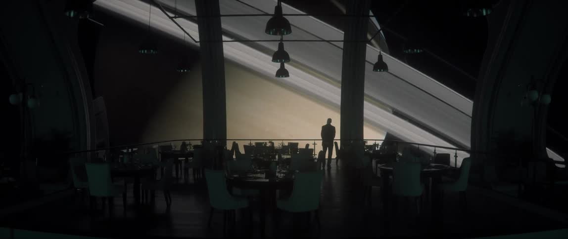 Man on a rotating space station facing the planet Saturn