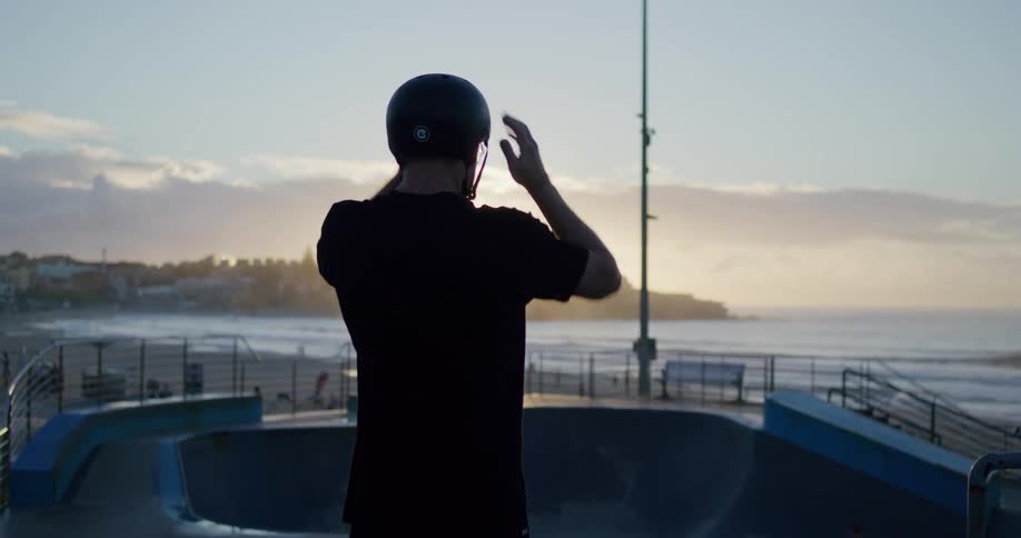 A man wearing a helmet by an empty pool