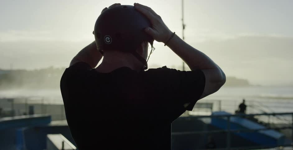 A man adjusting a helmet on his head