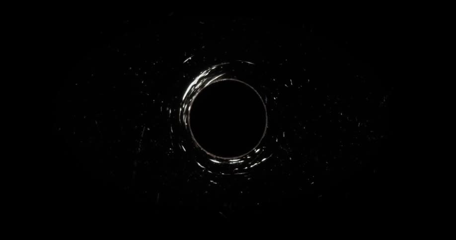 A visual effect of a void rippling and growing a halo