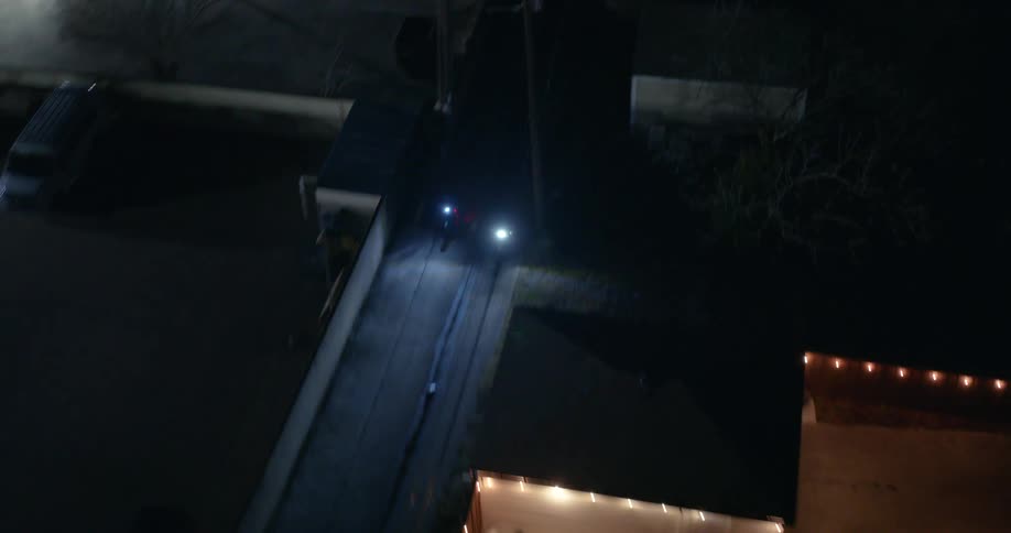 An aerial clip of two bikes moving in the night