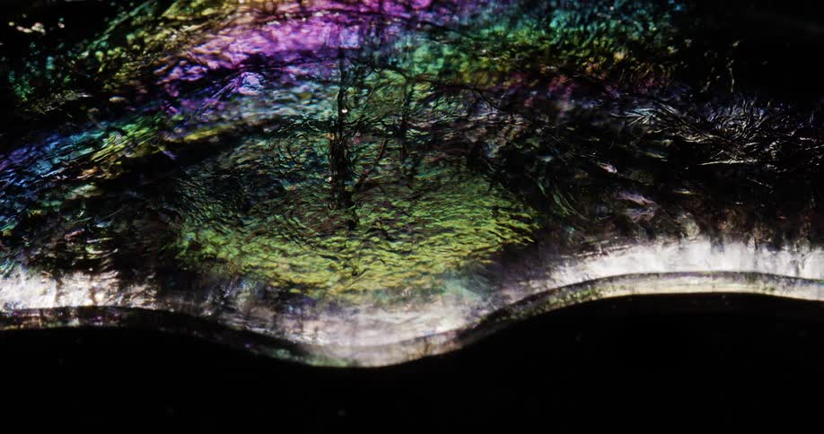 Fluid art with rainbow reflections in the water