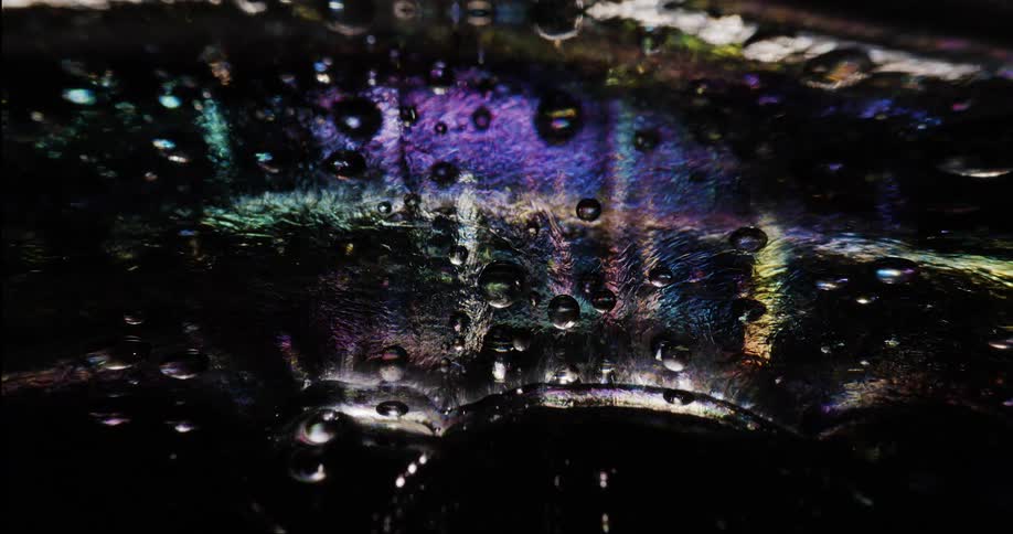 Extreme close up on small bubbles in an abstract shiny dense liquid