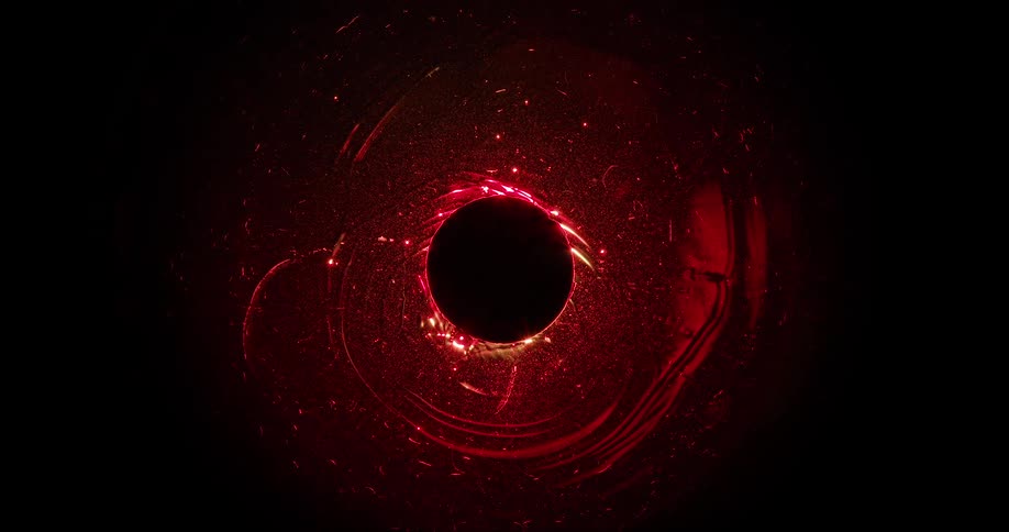 Abstract liquid in dark reddish color in motion expanding an email to a black hole