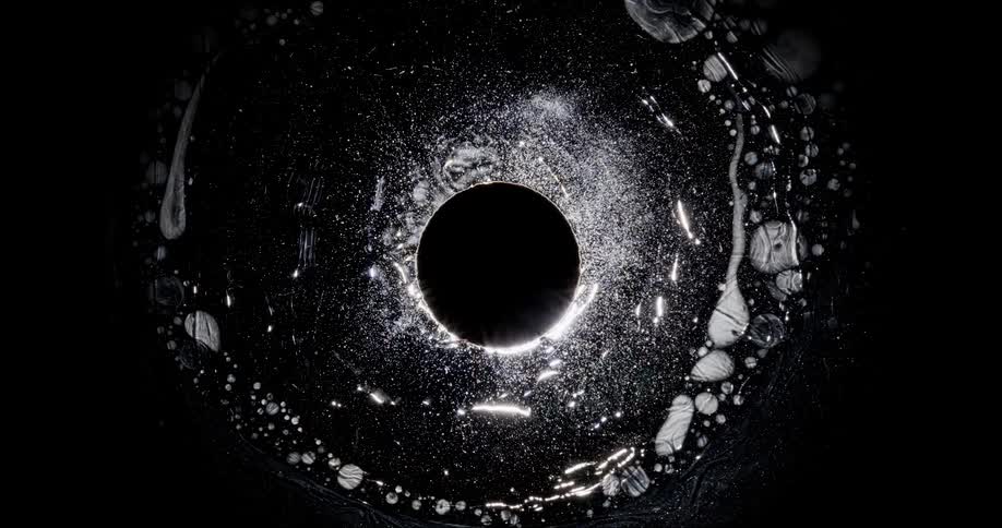 The black and white fluid moves around the hole
