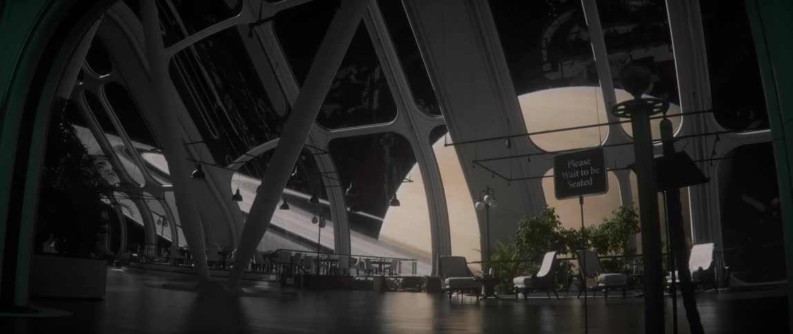 A futuristic rotating space station with seating areas near windows that offer a view of planet Saturn