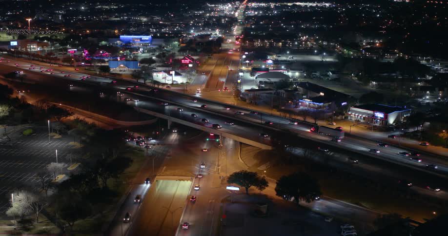 Aerial panorama of an overpass and roads in the middle of a city at night