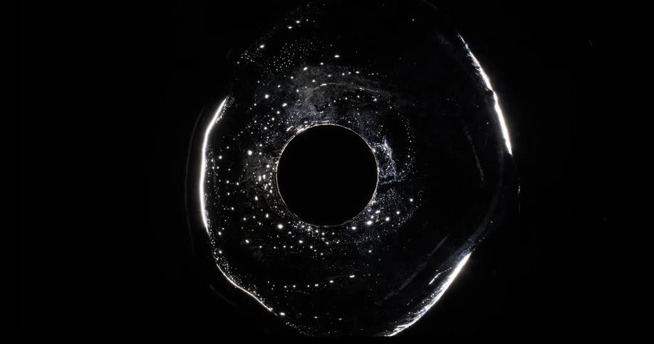 The liquid moves around the dark circle