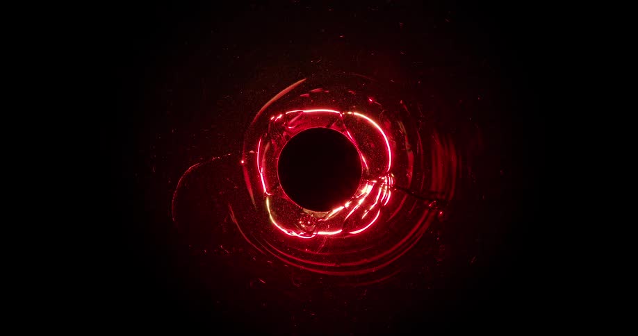 Glowing gel like liquid forms shapes while flowing around black disk