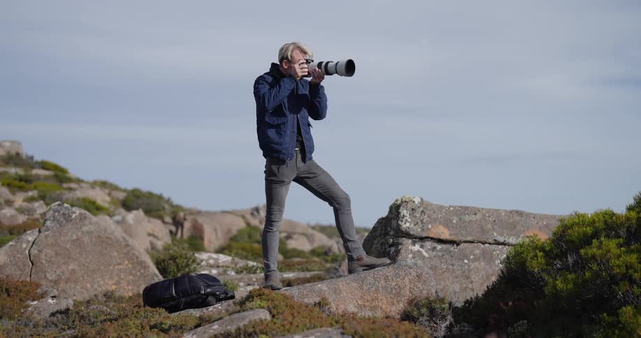 A man is taking pictures outside
