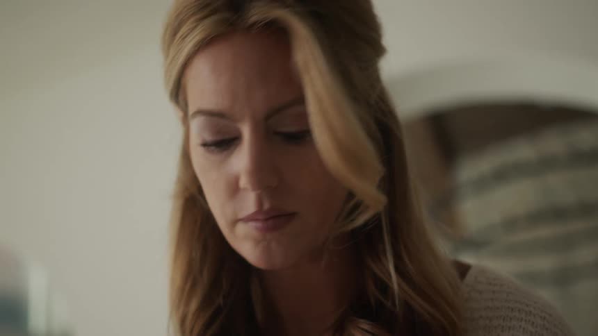 Portrait of a blonde woman indoors looking to the side