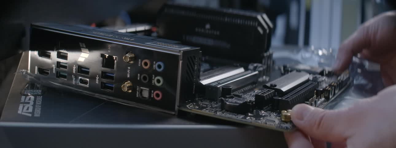 A worker moves a motherboard in a shop