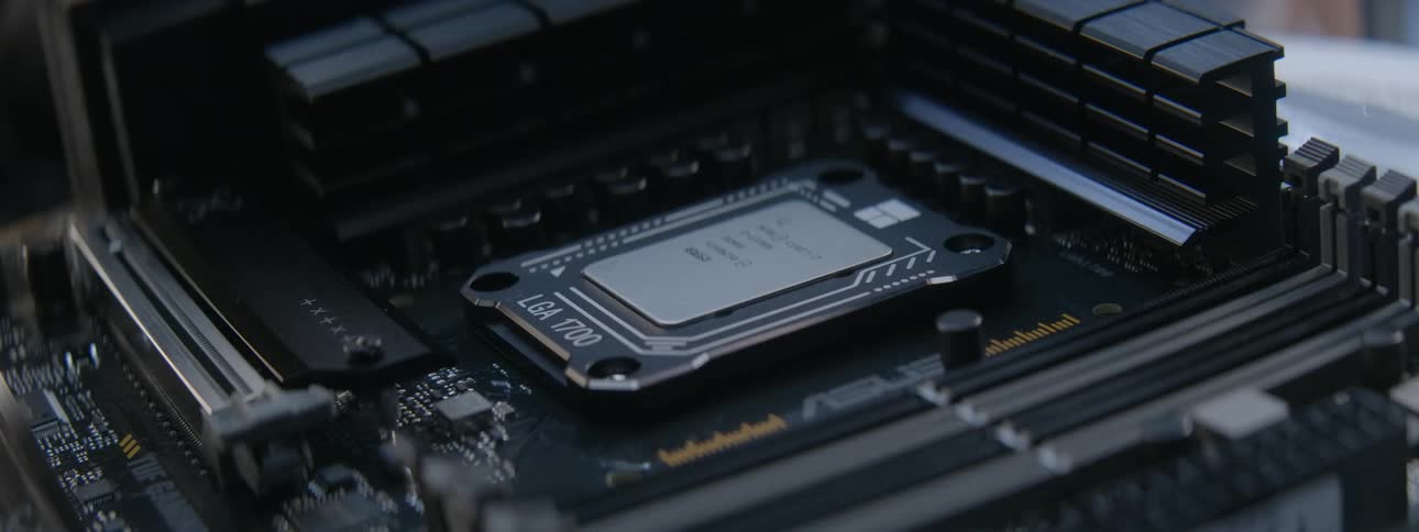 A man tightens screws on a motherboard