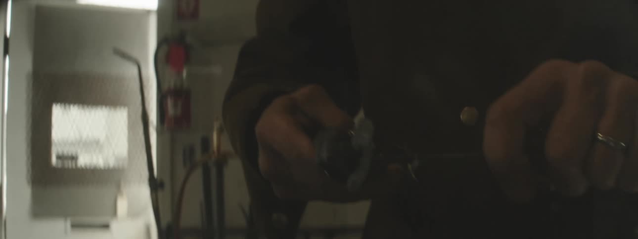 Closeup of a mans hands with metal welding pliers