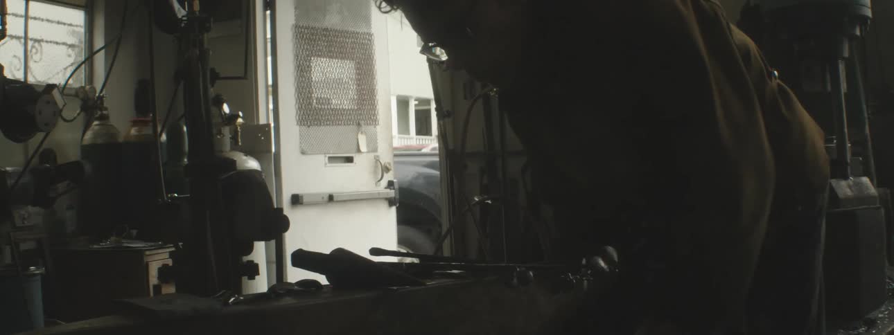 A blacksmith is working in his shop