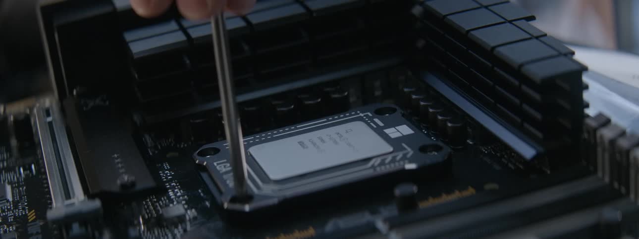 A person is screwing a cpu into the motherboard