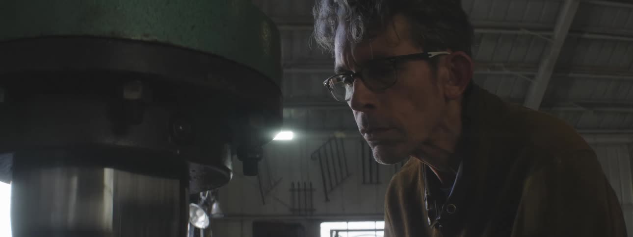 Close up of a man working with machinery in a workshop