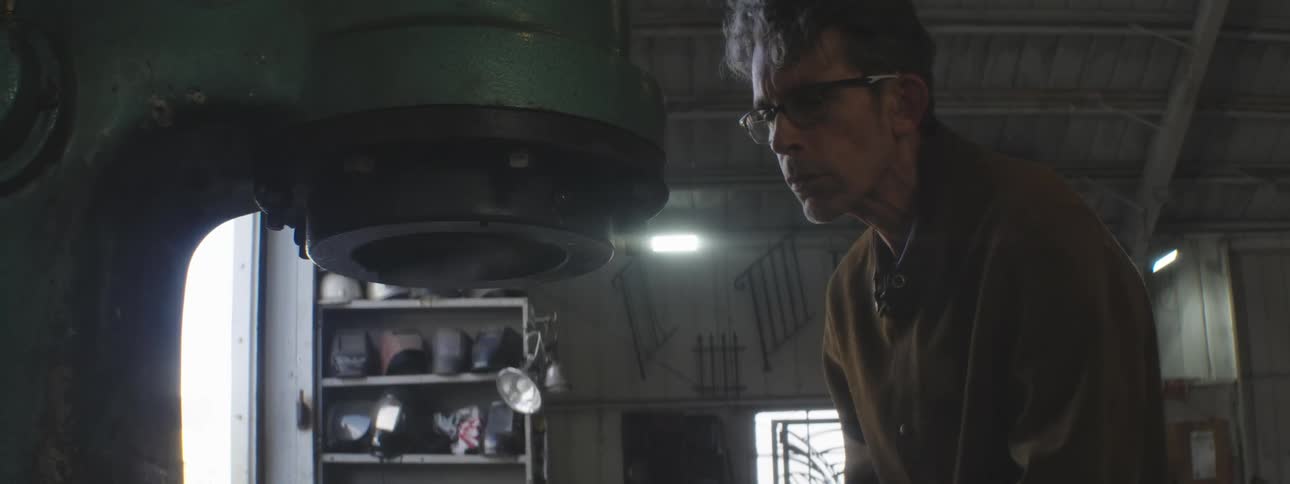 A large machine is being used to hammer metal