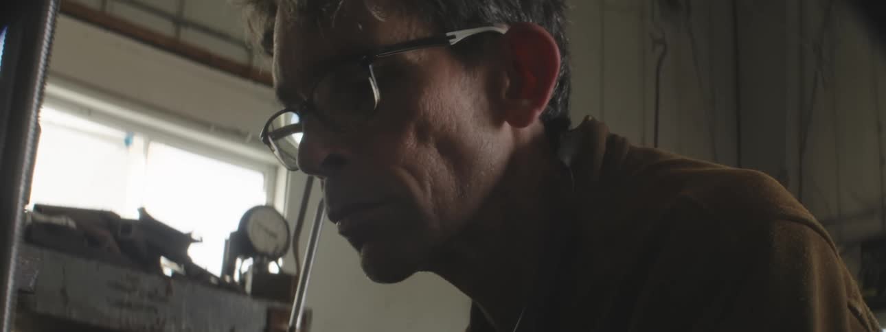 Man with man with prescription glasses concentrated working