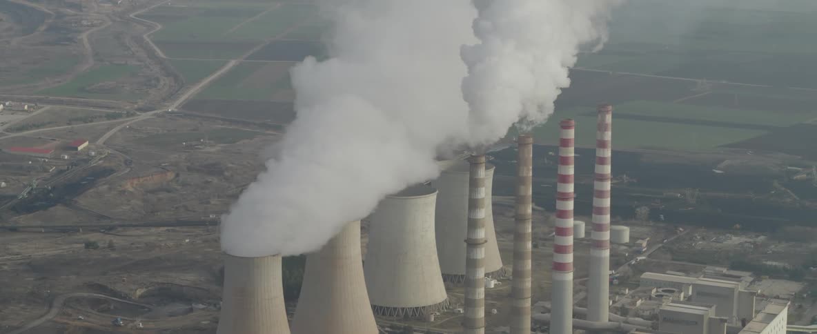 Smoke rises from towers at a power plant
