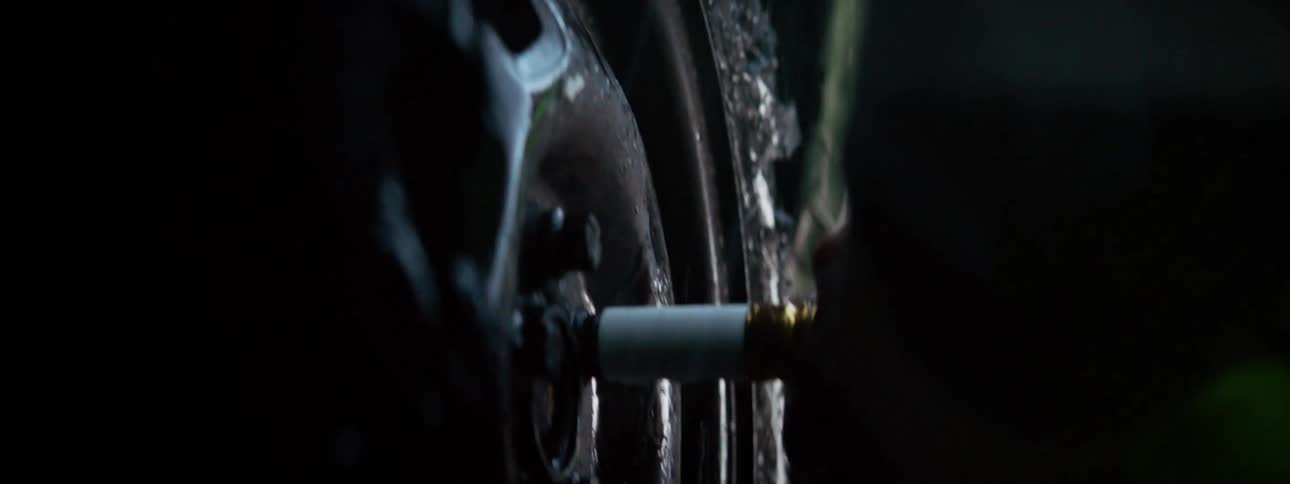 A man unscrews nuts on a car tire