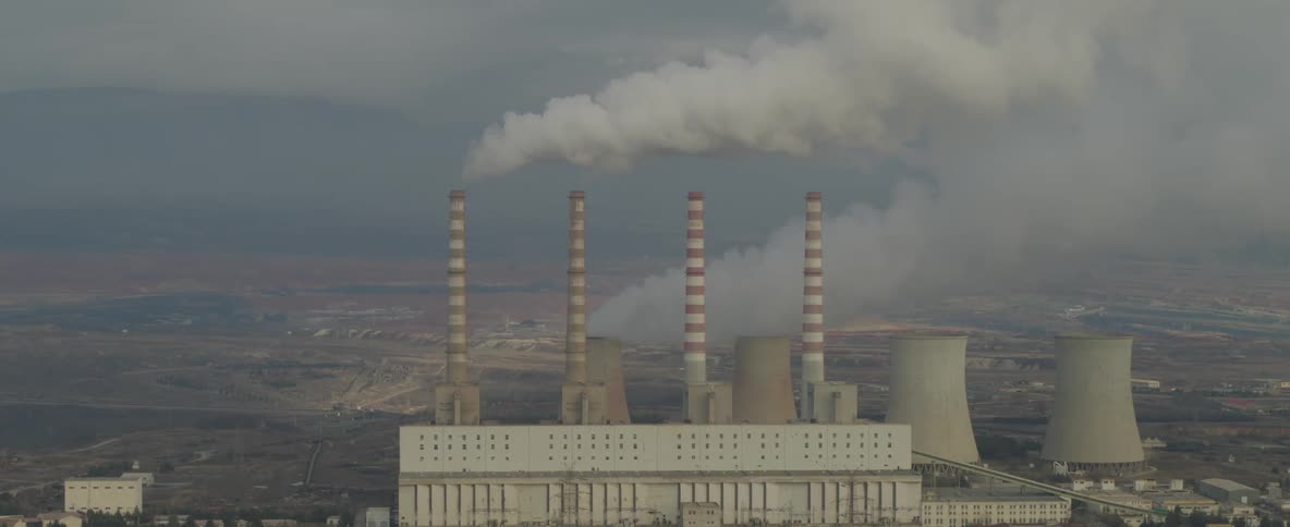 Smoke rises from the power plant chimneys
