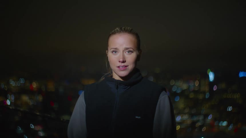 A woman takes a deep breath on the cold winter night