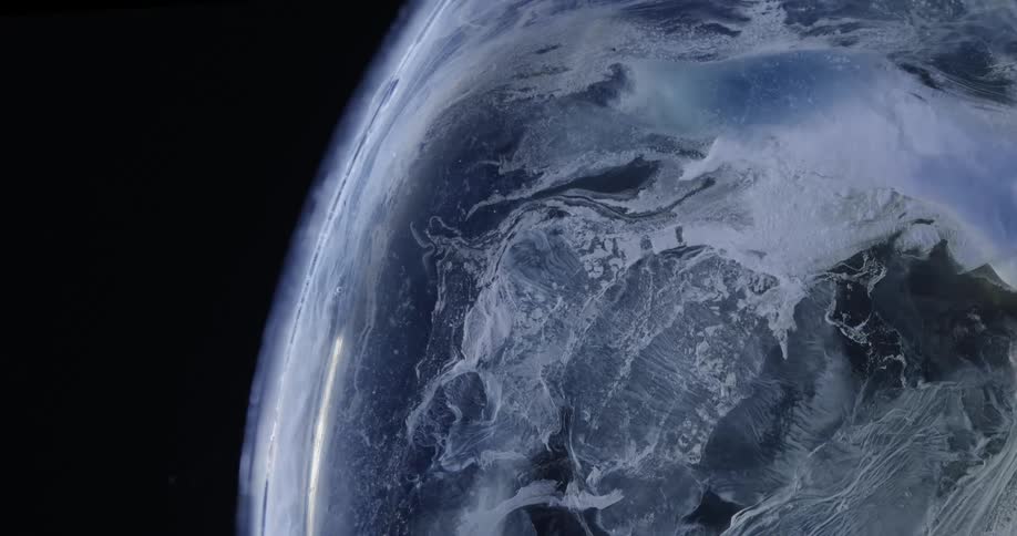 Extreme closeup on a soap bubble in slow motion on a dark background