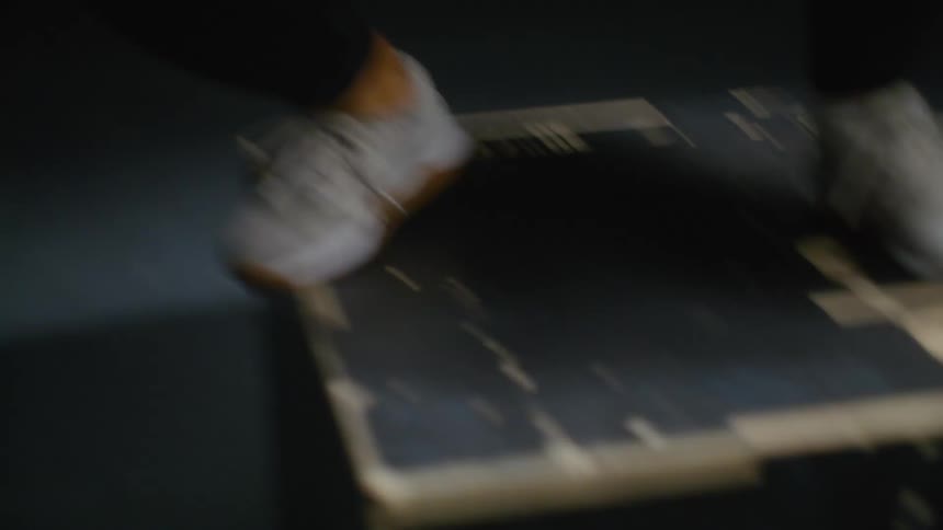 A person jumps into a dark wooden box