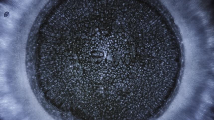 A computer effect of a circle filling in with a powder like substance